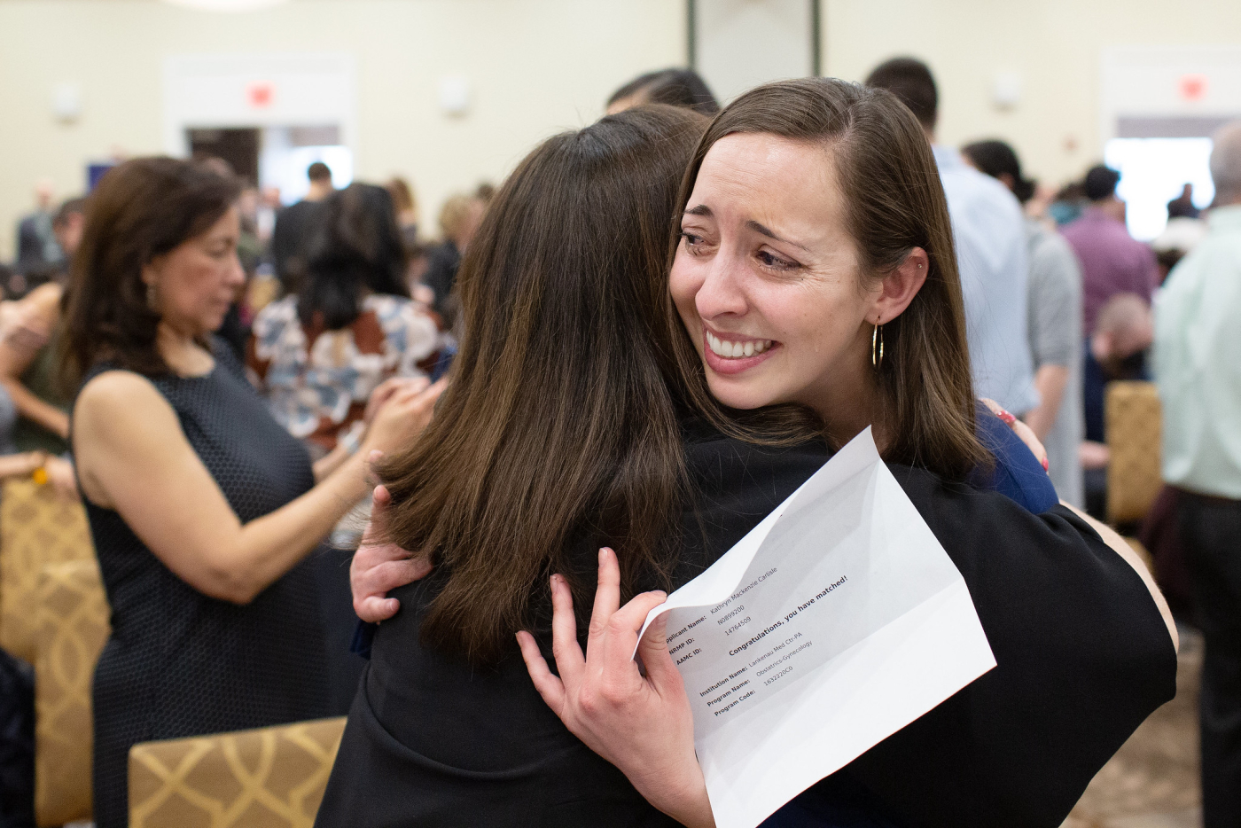 Kathryn Carlisle, facing, gets a hug from her mother, Mary Ann Carlisle, after her daughter matched with Lankenau Medical Center in Wynnewood, Pa., during Match Day at the Sheraton Harrisburg Hershey Hotel on Friday, March 17, 2023.